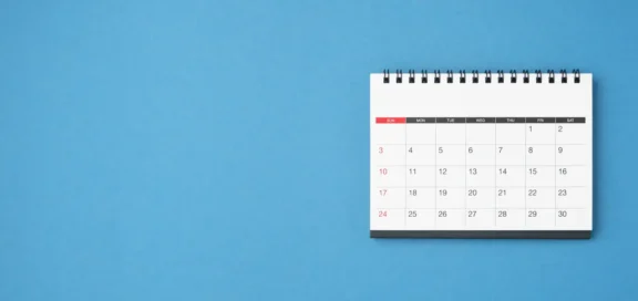 Desk calendar with monthly overview on blue background