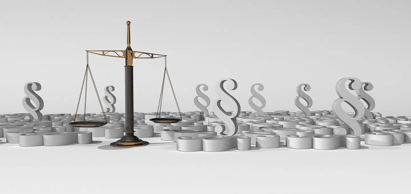 The scales of justice amidst numerous section symbols as a symbol of punishment proportionality